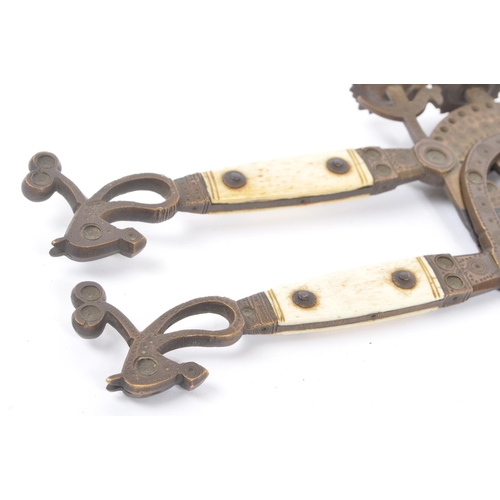 326 - Two 19th century Indian betel nut crackers. One having bone handles, with both having ornate dot wor... 