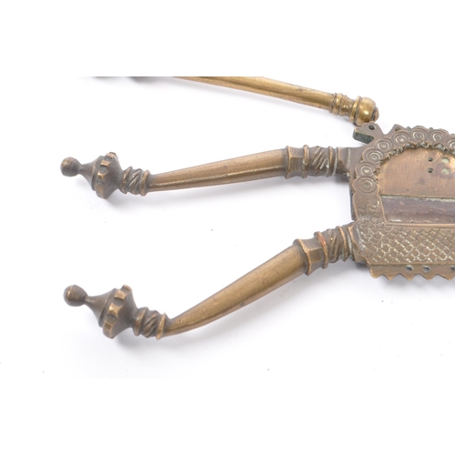 328 - A collection of three 19th century Indian betel nut crackers to include brass example with intricate... 