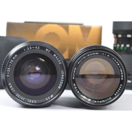 339 - Olympus - A collection of mid 20th century Olympus O/OM mount lenses and accessories. The collection... 