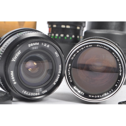 339 - Olympus - A collection of mid 20th century Olympus O/OM mount lenses and accessories. The collection... 