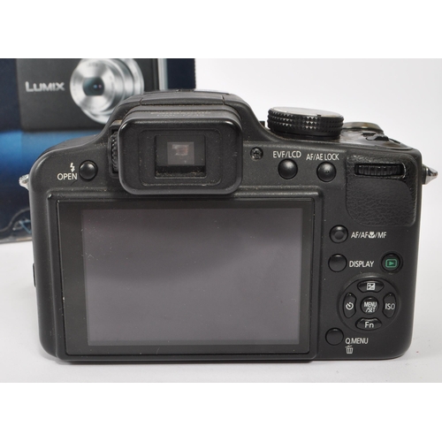 341 - Panasonic - A Panasonic digital bridge camera and compact digital camera. The collection to include ... 