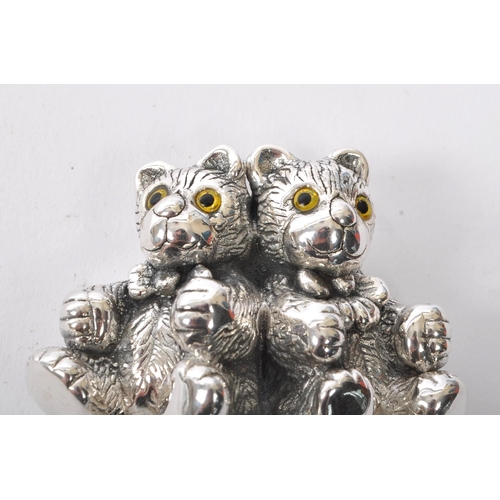 346 - A sterling silver babies rattle having mother of pearl style handle with figures of two bears finial... 