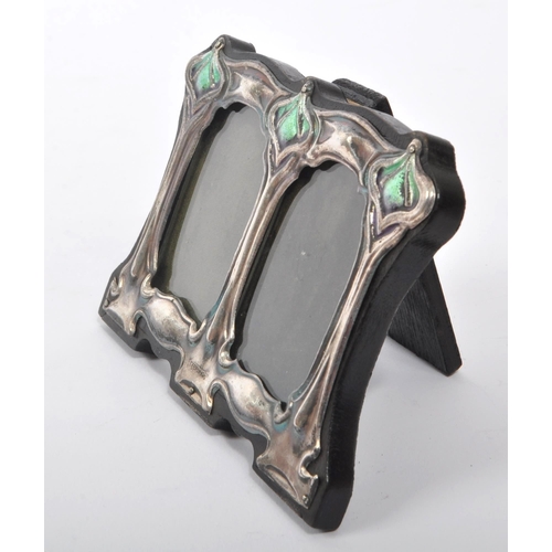 349 - A 20th Century easel back Liberty style double photo frame having Art Nouveau style sterling silver ... 