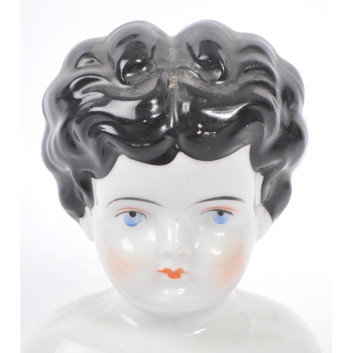 35 - An early 20th Century Art Deco china porcelain dolls head and shoulders, having hand painted feature... 