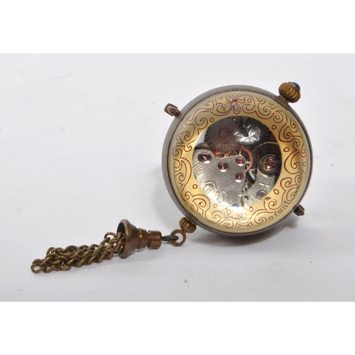 351 - A small 20th Century brass cased desk style ball clock / orb pocket watch of spherical form with bla... 