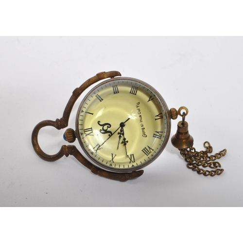 351 - A small 20th Century brass cased desk style ball clock / orb pocket watch of spherical form with bla... 