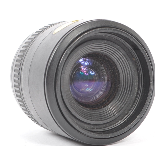 354 - Sigma - A Sigma EX 105mm F2.8 Macro AF lens. Serial number 1003012. Canon EF mount. Alongside a Tamr... 