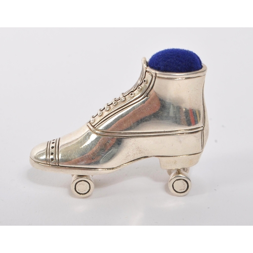 357 - A 20th Century vintage sterling silver pin cushion in the form of a roller skate having dark blue cu... 