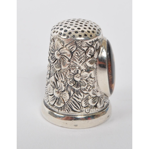 361 - A 20th Century vintage .925 sterling silver thimble with floral decoration and having an oval cameo ... 