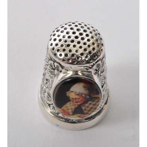 361 - A 20th Century vintage .925 sterling silver thimble with floral decoration and having an oval cameo ... 