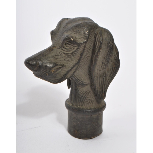 363 - A 20th Century vintage bronze walking cane handle in the form of a dog's head. Measuring approximate... 