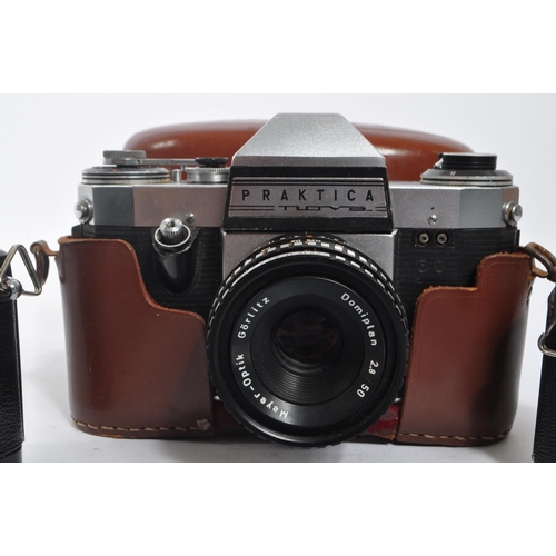 367 - Photographic Interest - A collection of three mid 20th century 35mm SLR cameras. The collection to i... 