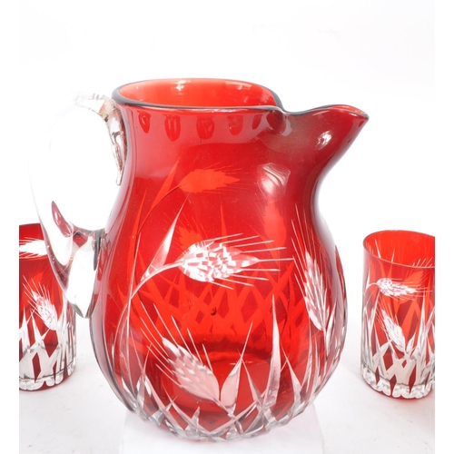 37 - A mid Century vintage Bohemian ruby / cranberry red cut glass drinking / lemonade set comprising of ... 