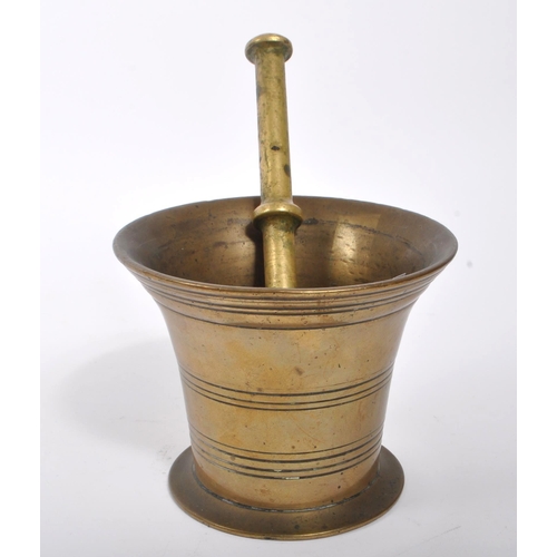 374 - A Victorian 19th century French manner brass pestle and mortar. Having a brass stick with round smoo... 