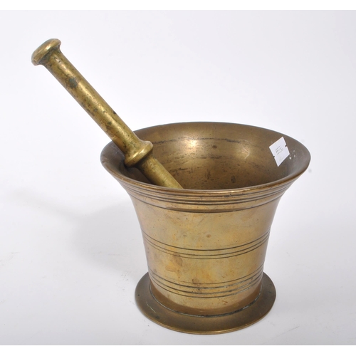 374 - A Victorian 19th century French manner brass pestle and mortar. Having a brass stick with round smoo... 