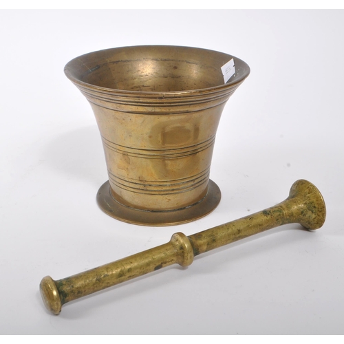 374 - A Victorian 19th century French manner brass pestle and mortar. Having a brass stick with round smoo... 