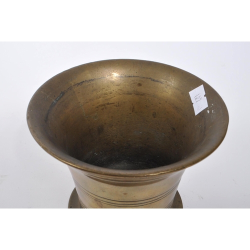 374 - A Victorian 19th century French manner brass pestle and mortar. Having a brass stick with round smoo... 