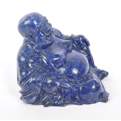 376 - A 20th century Chinese lapis lazuli semi precious stone carved buddha. The buddha in a seated laid b... 