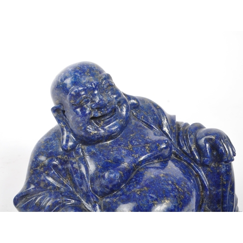 376 - A 20th century Chinese lapis lazuli semi precious stone carved buddha. The buddha in a seated laid b... 