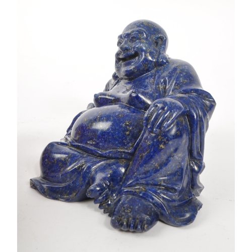 376 - A 20th century Chinese lapis lazuli semi precious stone carved buddha. The buddha in a seated laid b... 