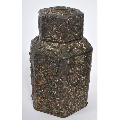 383 - A 19th century Chinese embossed white metal tea caddy. Having a hexagonal form lid with embossed flo... 