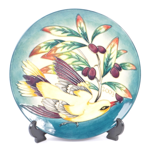 384 - Moorcroft - A china Moorcroft Pottery plate in the ' Golden Oriole ' pattern designed by Philip Gibs... 