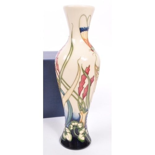 386 - Moorcroft - A china Moorcroft Pottery slim vase in the ' Grasshopper ' pattern designed by Philip Ri... 