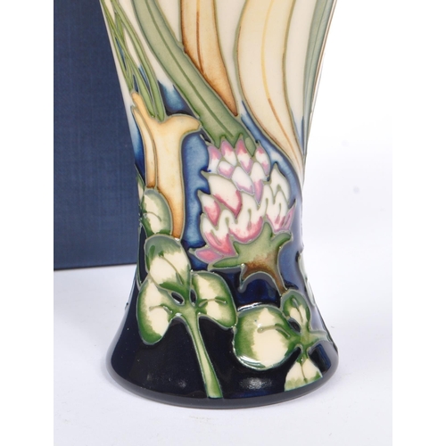 386 - Moorcroft - A china Moorcroft Pottery slim vase in the ' Grasshopper ' pattern designed by Philip Ri... 