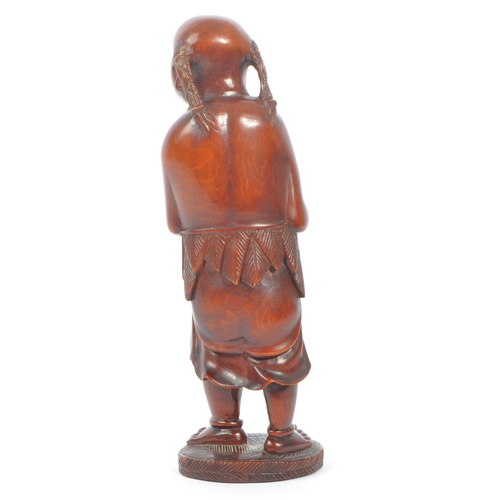 391 - A Japanese early 20th century hand carved wood figure of Liu Hai. Standing positing with bone teeth ... 