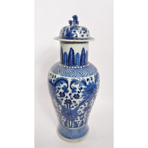 398 - A Chinese 19th century blue and white Qing dynasty table vase. With floral and foliate design to tap... 