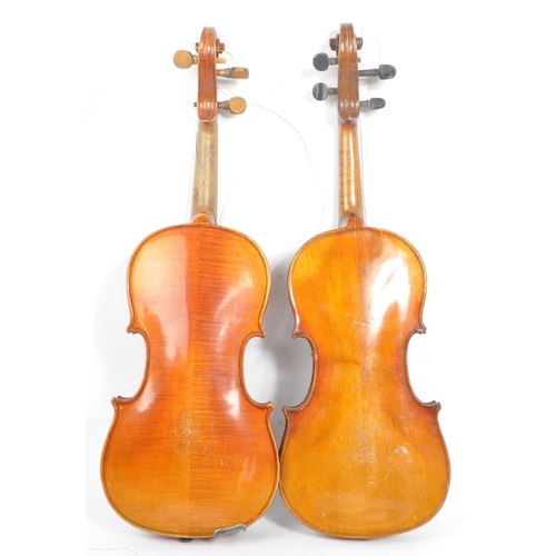 401 - Two early 20th century violin stringed musical instruments. Having a spruce wooden body with tuning ... 