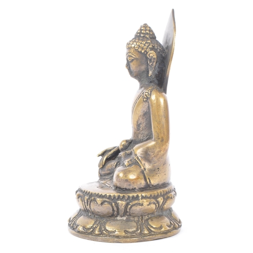 437 - Early 20th century brass Tibetan religious Buddha. Seating in the medicine pose on an oval base. Mea... 