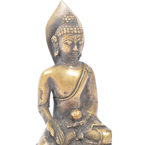 437 - Early 20th century brass Tibetan religious Buddha. Seating in the medicine pose on an oval base. Mea... 