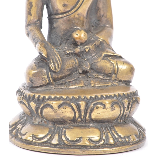 437 - Early 20th century brass Tibetan religious Buddha. Seating in the medicine pose on an oval base. Mea... 