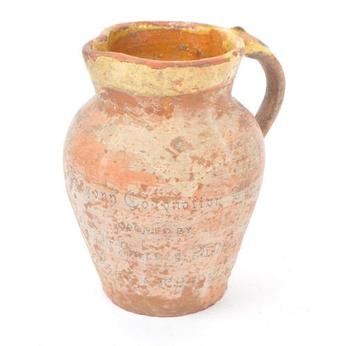 46 - A early 20th century George V clay pottery water jug. Commemorative water jug with handle and round ... 