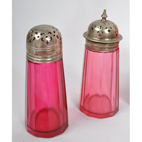 57 - A collection of Victorian 19th century cranberry cut glass. To include two sugar sifters, hand bell,... 