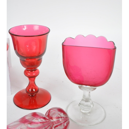 57 - A collection of Victorian 19th century cranberry cut glass. To include two sugar sifters, hand bell,... 