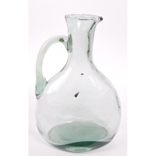 68 - A 19th century blown glass jug / carafe. The jug having a bulbous body, with a round neck and flared... 