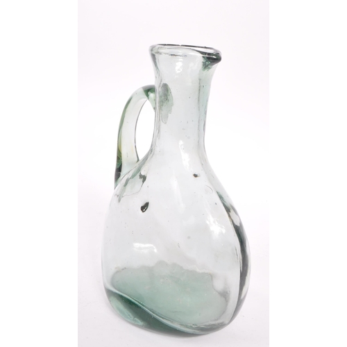 68 - A 19th century blown glass jug / carafe. The jug having a bulbous body, with a round neck and flared... 