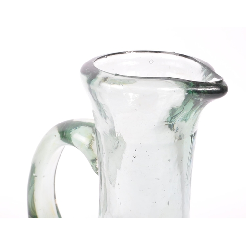 68 - A 19th century blown glass jug / carafe. The jug having a bulbous body, with a round neck and flared... 