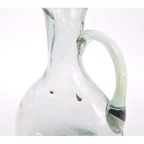 68 - A 19th century blown glass jug / carafe. The jug having a bulbous body, with a round neck and flared... 