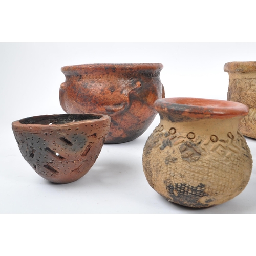 70 - A collection of terracotta / clay tribal folk art pots. The collection to include a large rounded po... 