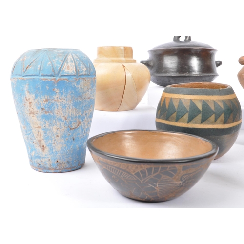 76 - A large collection of ceramic tribal folk art bowls, pots, and vases. The collection to include a va... 