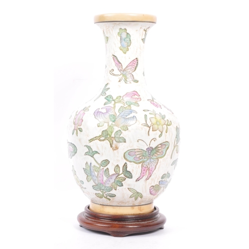 95 - A 20th century Chinese porcelain baluster vase. The vase having white ground and being hand painted ... 