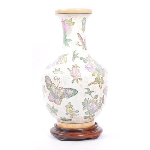 95 - A 20th century Chinese porcelain baluster vase. The vase having white ground and being hand painted ... 