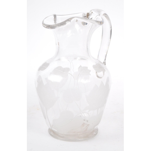 96 - A 20th century etched glass water jug with accompanying goblet drinking glasses in the manner of Tif... 