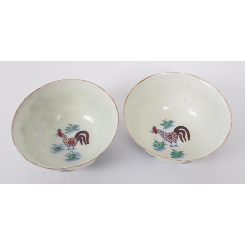 98 - A pair of early 20th Century Chinese porcelain tea bowls having hand painted motif of rooster / chic... 