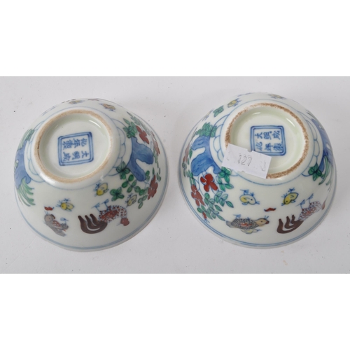 98 - A pair of early 20th Century Chinese porcelain tea bowls having hand painted motif of rooster / chic... 