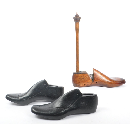 319 - A pair of early 20th century cast iron cobblers / shoemakers lasts, alongside another wooden example... 