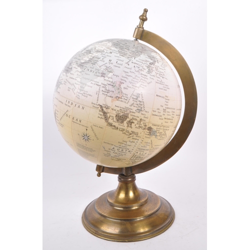 320 - A large vintage 20th century desk top globe. The globe featuring a brass style mounting, raised on a... 